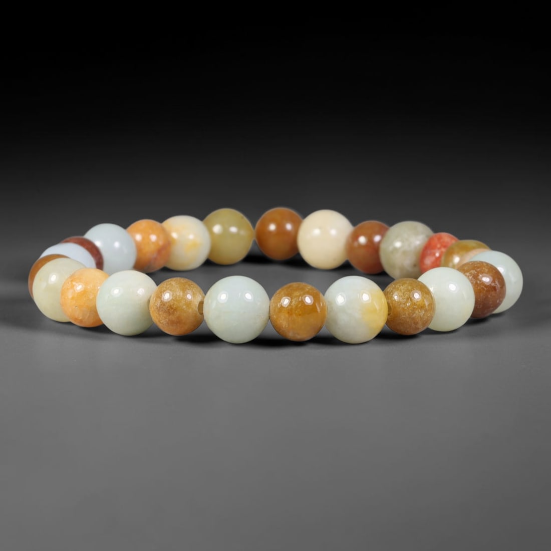 Natural Burmese Type A Mixed Earth Tone Jadeite Jade Bead Bracelet, 98TK: Strung from natural Type A Burmese jadeite, this spherical bead bracelet combines creamy white, pale celadon, honey gold, amber and subtle russet red tones across its polished beads. Each bead is even