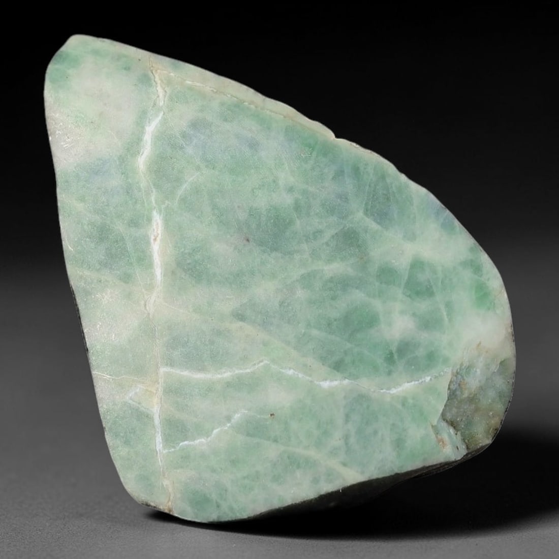 125ct Natural Type A Burmese Jadeite Jade Sliced Rough, 80YN: This specimen is a sliced rough block of natural Type A Burmese jadeite jade. The interior displays natural colour zoning with visible mineral veining and crystalline patterns typical of unprocessed j