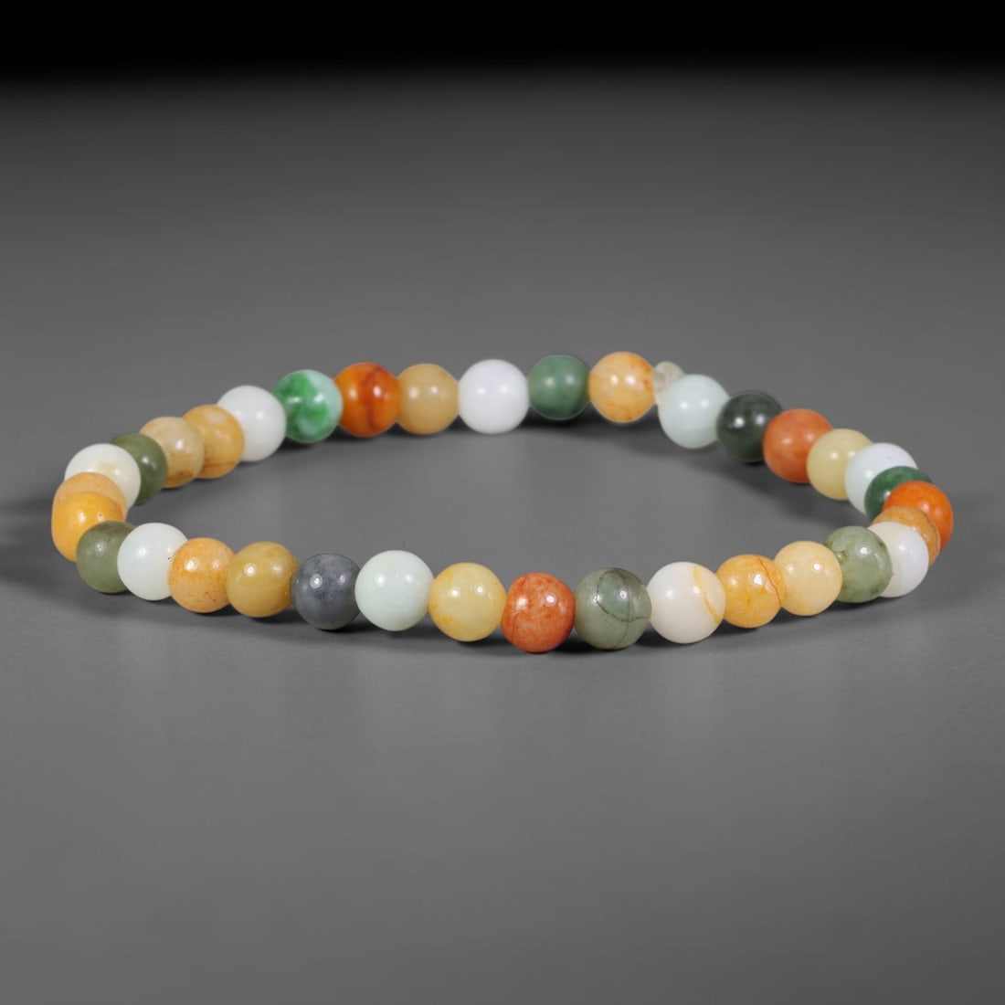 Natural Burmese Type A Multi-Colour Jadeite Jade Beaded Bracelet, 28TA: Strung from untreated natural Burmese Type A jadeite jade spherical beads with maximum bead dimension of 6.40mm, this bracelet strand features a sleek smooth polished finish showcasing mixed pale gree