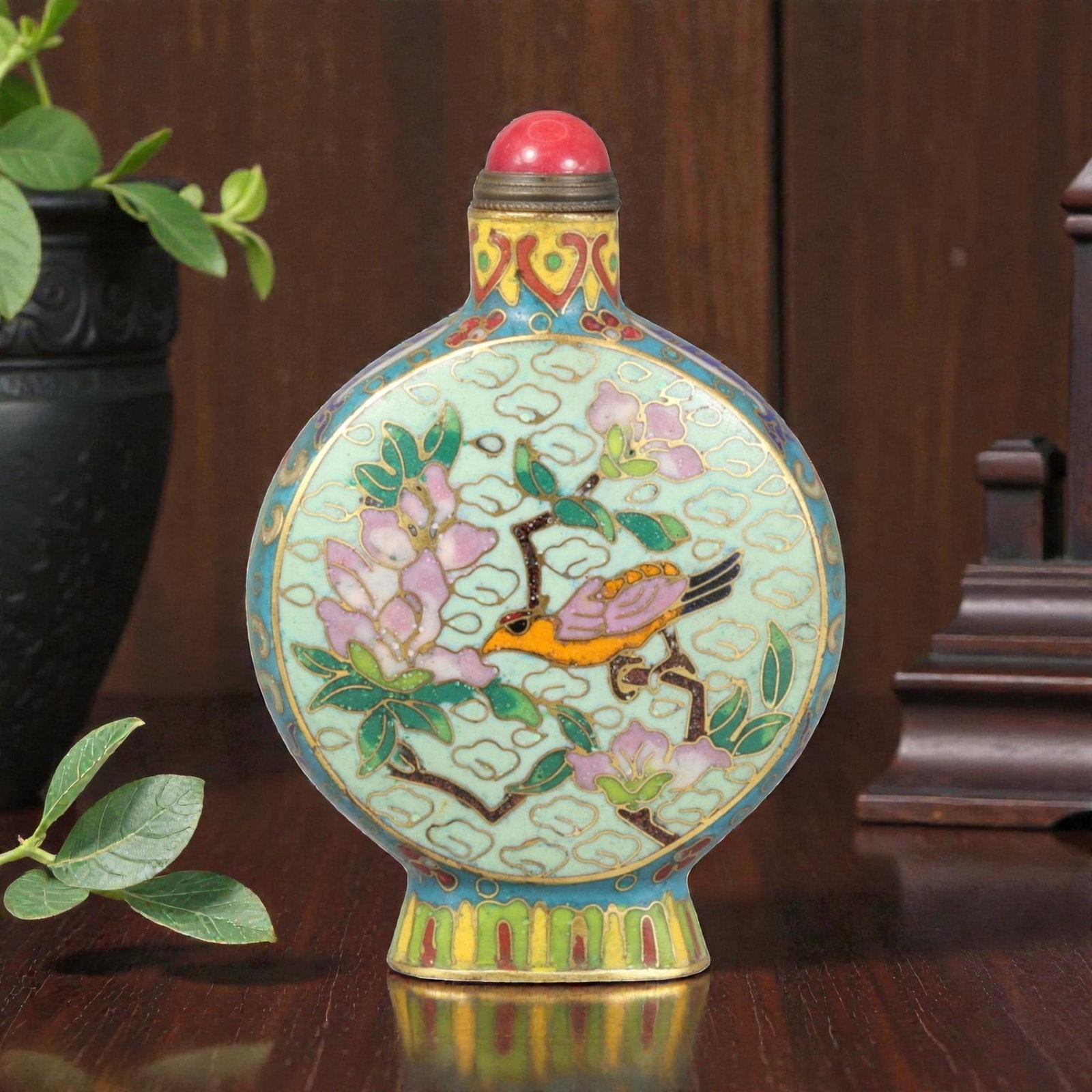 A Chinese Cloisonne Enamel Snuff Bottle, 20th Century, 19YC: Constructed from metal and decorated in cloisonne enamel, the bottle is of compressed globular form with rounded sides rising to a short cylindrical neck and flared foot. The surface is articulated wi