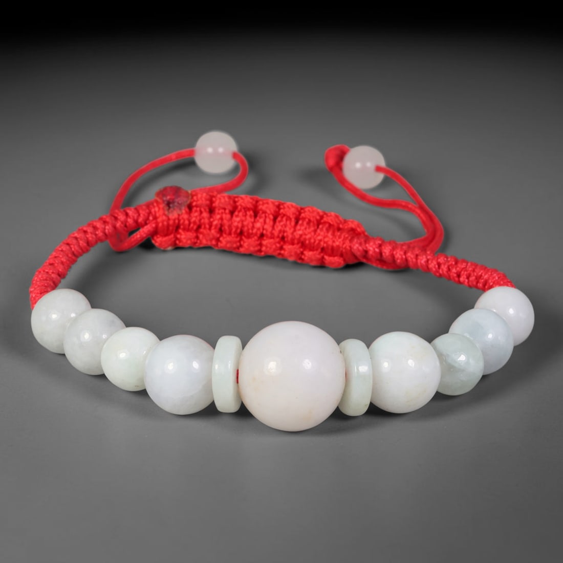 Natural Burmese Type A Milky White Round Jadeite Jade Adjustable Red Braided Bracelet, 63TA: Handcrafted from untreated natural Burmese Type A milky white jadeite, this scarlet woven cord bracelet features a prominent central spherical jadeite bead measuring 14.18 mm, framed by thin flat jade