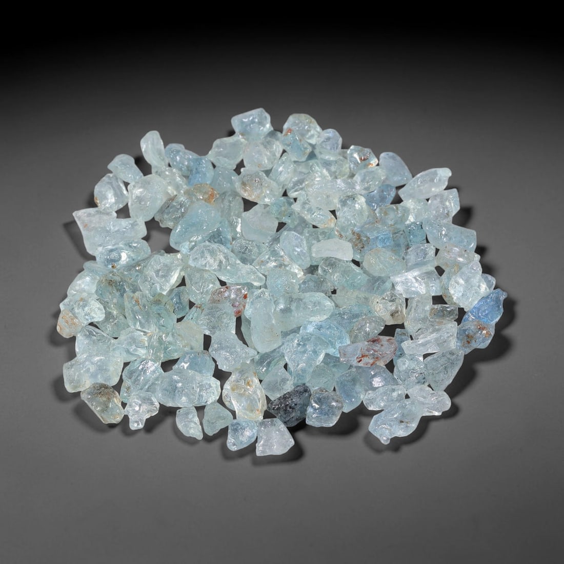142.36 Carats Natural Aquamarine Rough Parcel, 72WV: This luminous parcel of natural aquamarine rough showcases the classic soft sky-blue hue the gem is known for, ranging from pale, translucent tones to deeper, more saturated blues. The stones are in t