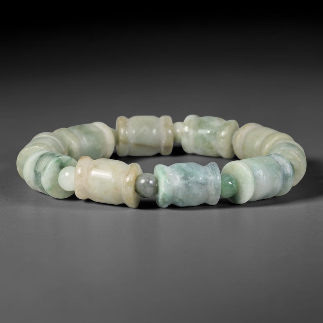 Natural Burmese Type A Carved Waisted Barrel Jadeite Jade Bead Bracelet, 10TP: Strung from natural Type A Burmese jadeite, this bracelet features carved waisted barrel beads with blended pale celadon green, creamy off-white and soft honey-yellow undertones, interspersed with sma