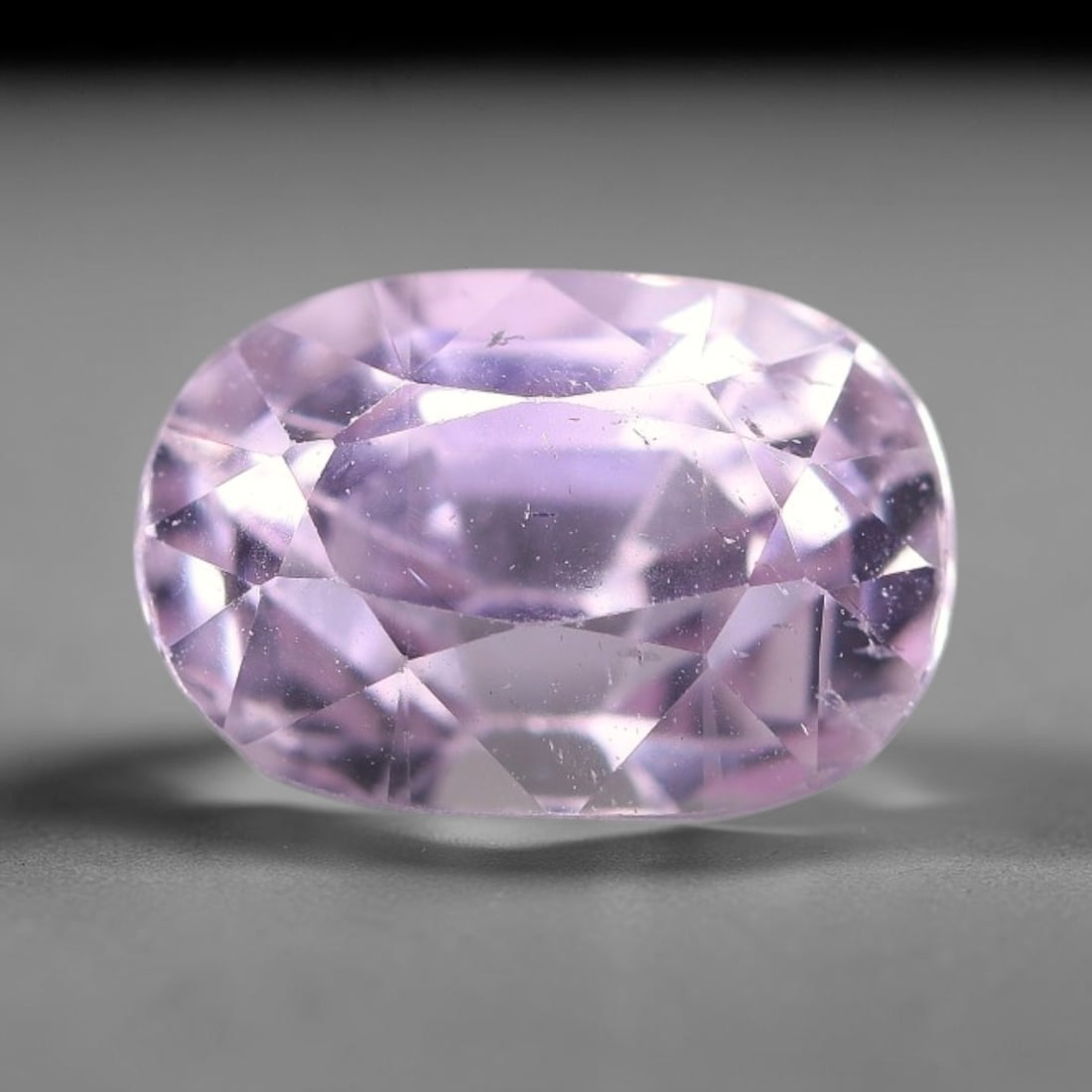 4.47ct Natural Pale Lavender Kunzite Oval Cut Loose Gemstone, 72TH: This faceted specimen is natural kunzite, fashioned in an oval brilliant cut. The stone displays a translucent pale lavender hue, with fine scattered particulate inclusions and faint internal linear m