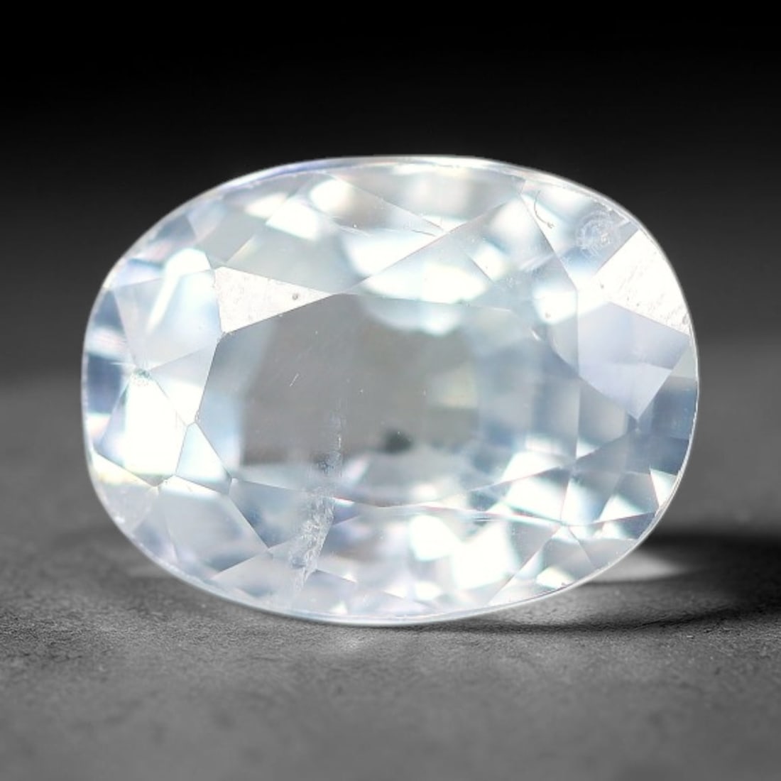 2.38ct Natural White Topaz Oval Faceted Gemstone, 87WW: Expertly faceted natural white topaz with excellent clarity and brilliant light reflection across precisely cut facets. The stone carries a clean colourless body tone, showcasing inherent natural subt