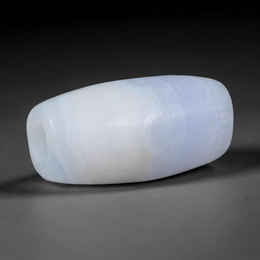 Ancient Sogdian Soft Lavender Banded Chalcedony Slim Barrel Amulet Bead (500-1000 CE), 35XD: This delicate tapered barrel chalcedony bead was hand-carved by Sogdian Silk Road stone artisans, designed as lightweight subtle talismans for fine layered necklaces traded across Central Asian carava