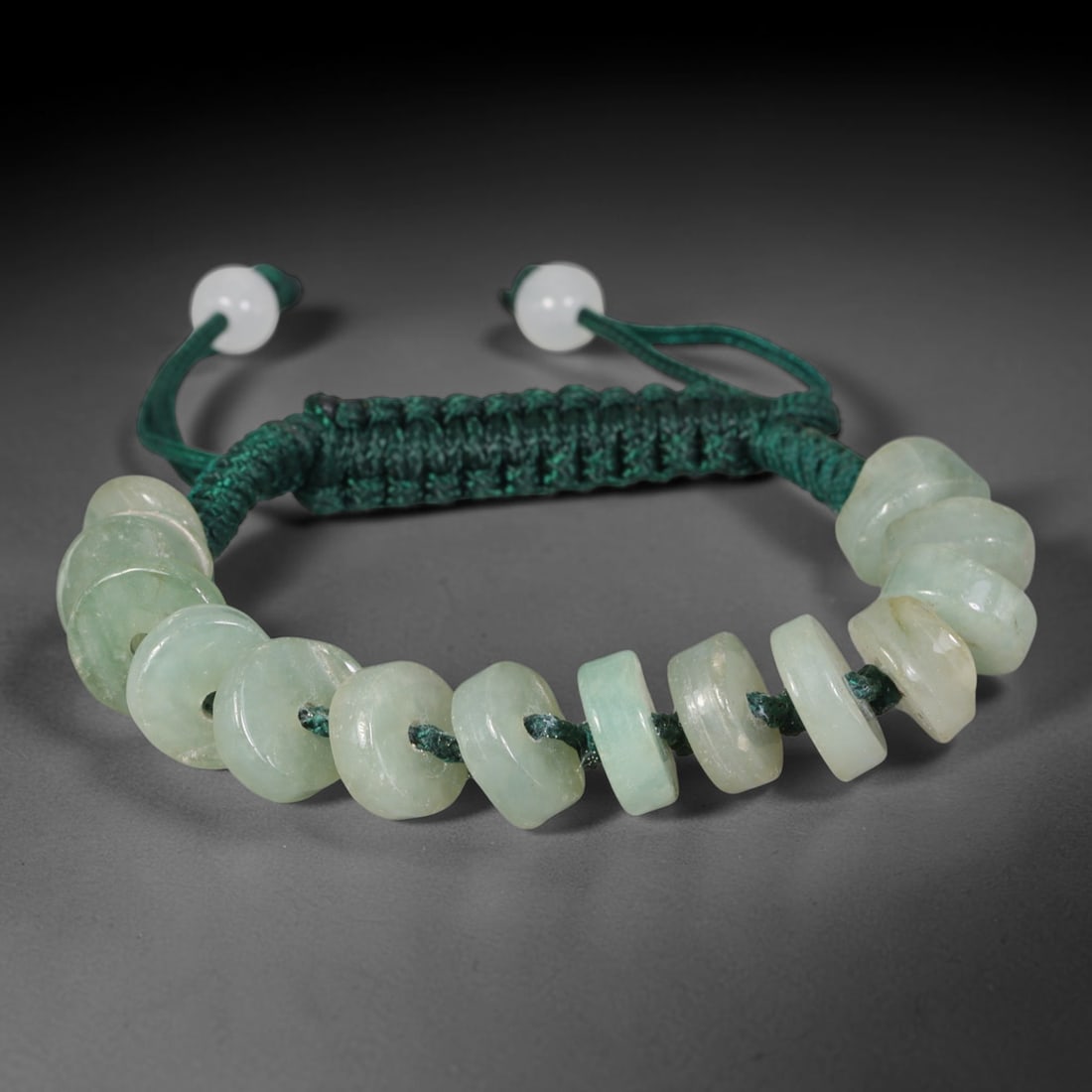 Natural Burmese Type A Pale Green Donut Jadeite Jade Adjustable Braided Bracelet, 56TA: Crafted from untreated natural Burmese Type A pale green jadeite, this braided cord bracelet features flat circular donut beads each measuring 10.65 mm in thickness, showcasing soft translucent pale g
