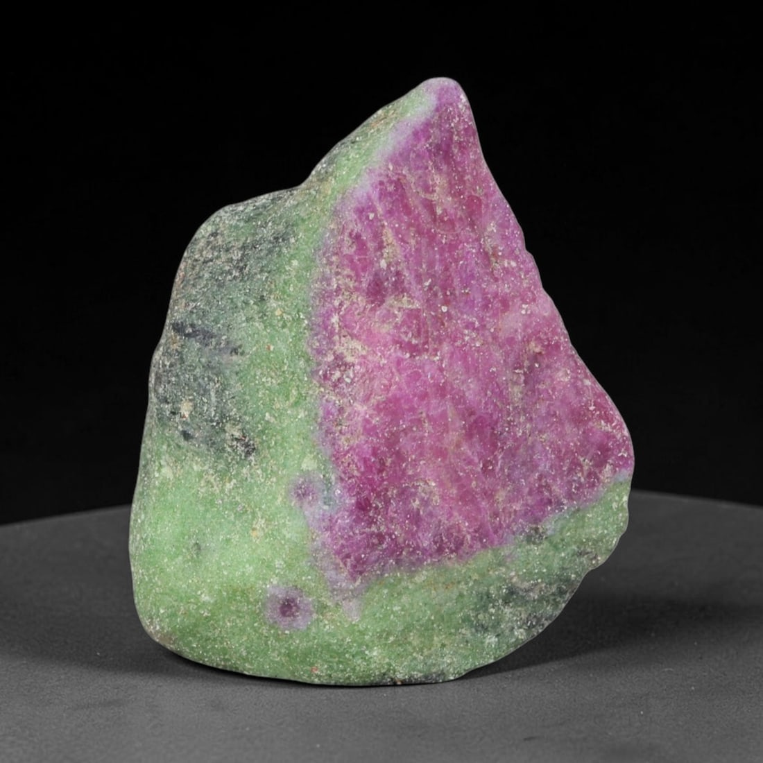 143.38ct Natural Tanzanian Ruby Zoisite Raw Rough Specimen Mineral Stone, 60YT: This unpolished mineral rough is natural ruby zoisite sourced from Tanzania, exhibiting distinct banded mineral segregation of vibrant green zoisite, magenta ruby crystals, and dark hornblende inclusi