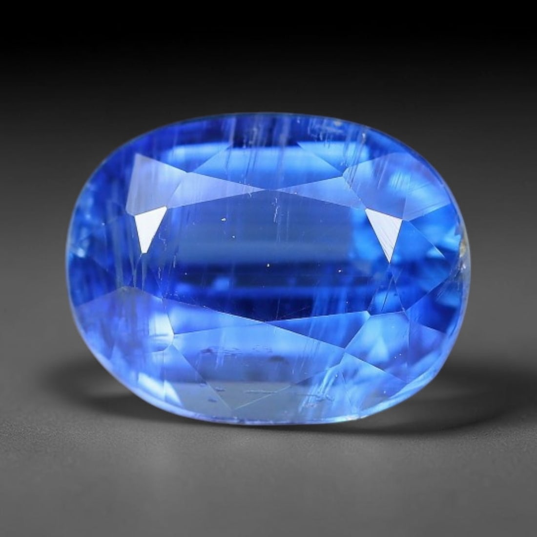 1.91 Carats Natural Brazilian Kyanite Oval Faceted Loose Gemstone, 59XY: This specimen consists of natural kyanite mineral material refined via professional faceted lapidary work, with uniform polished surfaces across the crystal exterior. Natural internal particulate mark