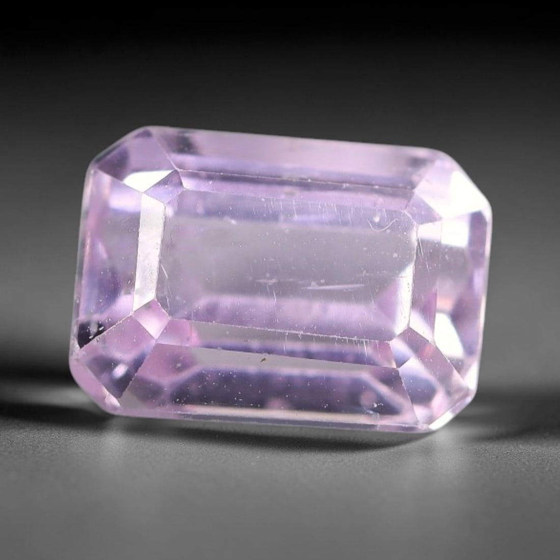 3.30ct Natural Pale Pink Lavender Kunzite Emerald Cut Loose Gemstone, 70TH: This faceted specimen is natural kunzite, fashioned in an emerald cut. The stone features a translucent pale pink lavender hue, with fine scattered particulate inclusions and faint internal linear tra