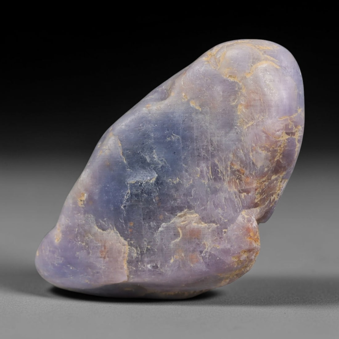 86ct Natural Unheated Sri Lankan Purplish Blue Sapphire Rough, 24YQ: This natural corundum rough is an unheated purplish blue sapphire sourced from Sri Lankan alluvial gem deposits, featuring an irregular natural native form with residual pale yellow-brown mineral matr