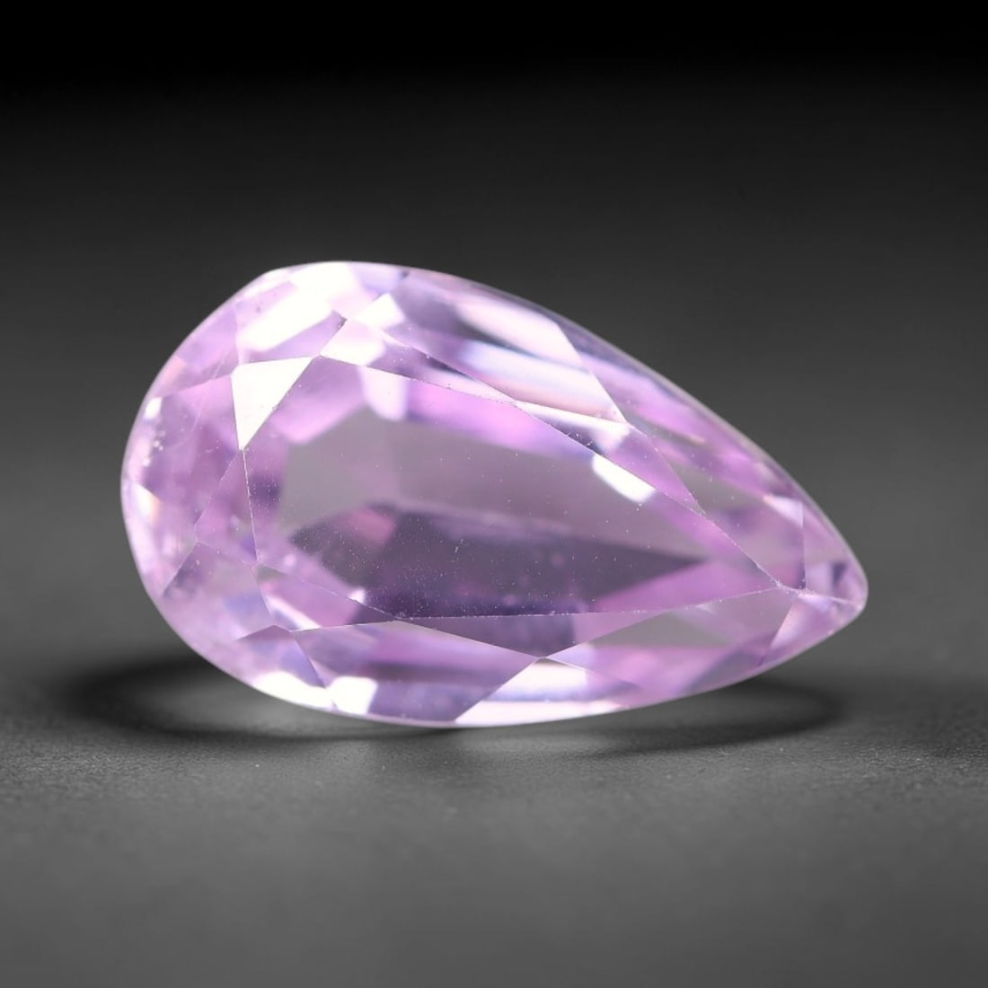 5.76ct Natural Pink Lavender Kunzite Pear Cut Loose Gemstone, 67TH: This faceted specimen is natural kunzite, fashioned in a pear cut. The stone presents a translucent pink lavender hue, with fine microscopic particulate inclusions scattered throughout the crystal mat