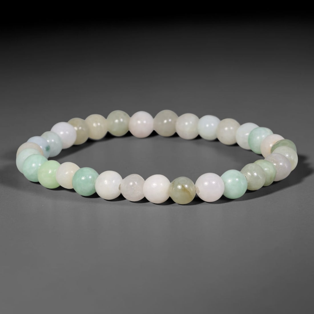 Natural Burmese Type A Multi-Colour Jadeite Jade Beaded Bracelet, 84TA: Strung from untreated natural Burmese Type A jadeite jade spherical beads with maximum bead dimension of 6.92mm, this bracelet strand features a sleek smooth polished finish showcasing mixed pale gree