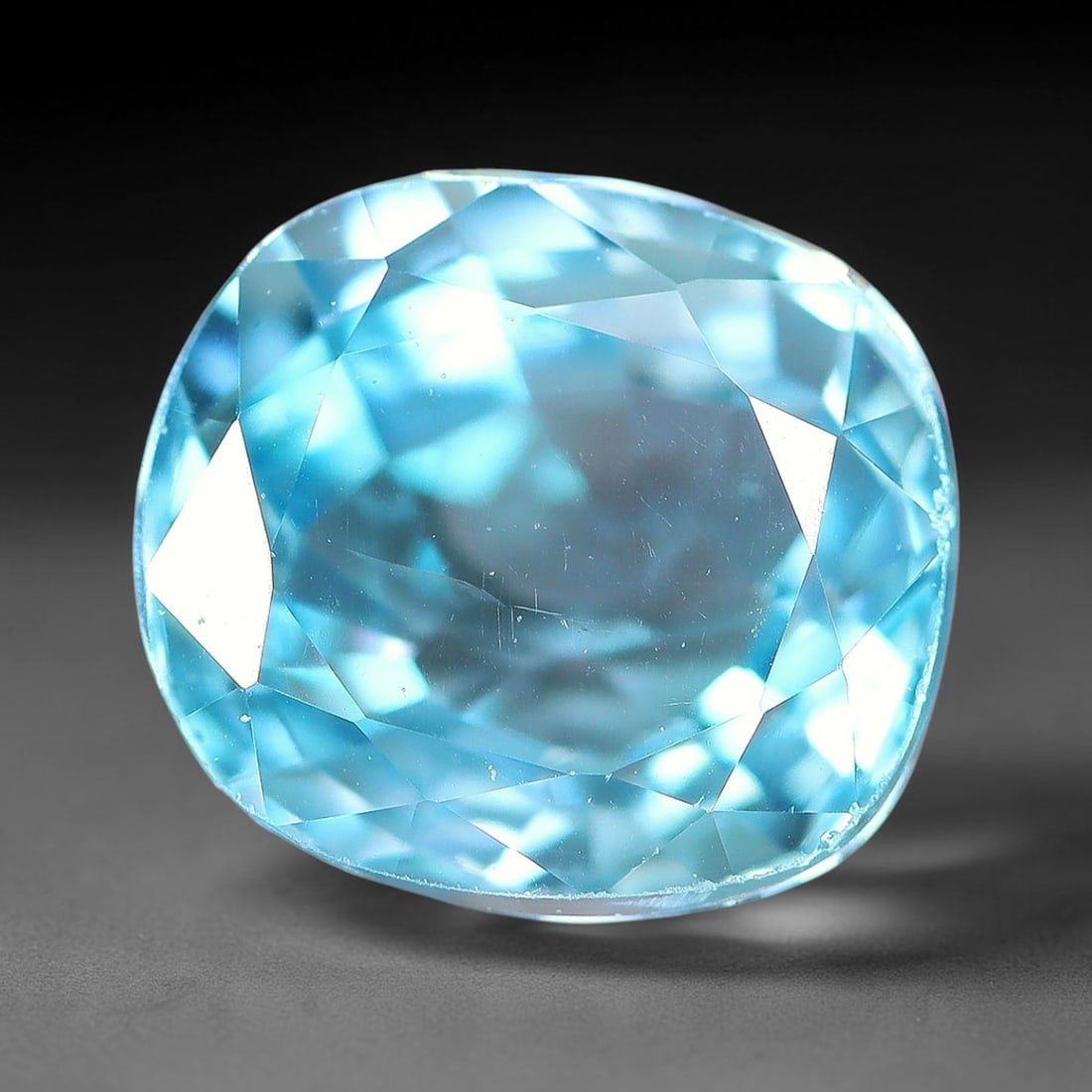 3.09ct Natural Sky Blue Zircon Oval Cut Loose Gemstone, 21TM: This faceted specimen is natural zircon, fashioned in an oval brilliant cut. The stone displays a translucent sky blue hue, with fine internal inclusions visible within the crystal structure. Faceting