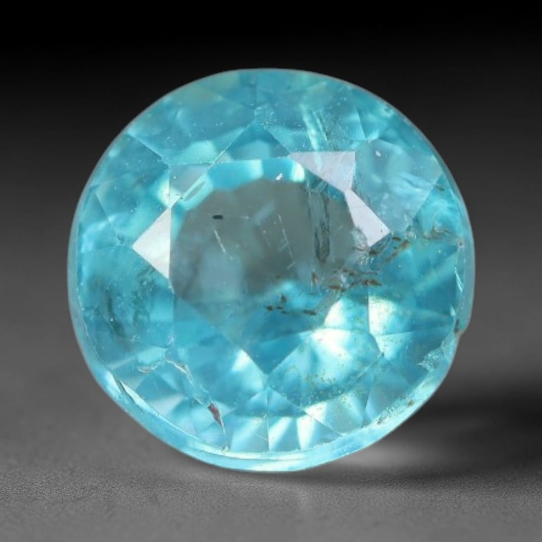 1.04 Carats Natural Bright Cyan Blue Apatite Round Faceted Loose Gemstone, 14WW: This apatite is sourced from natural mineral deposits and processed with precise faceting and uniform high-gloss polishing by professional lapidary craftsmanship. Natural fibrous textures and tiny sca