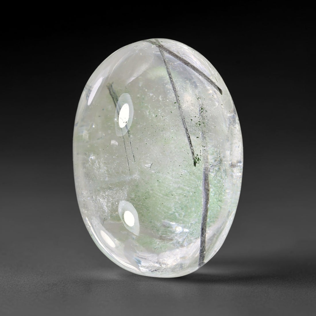 25.37ct Natural Brazilian Black Rutile Quartz Cabochon Loose Gemstone, 14YX: This polished cabochon of natural rutile quartz features countless distinct slender black rutile needle inclusions suspended within the clear quartz host crystal. The smooth domed surface enables full