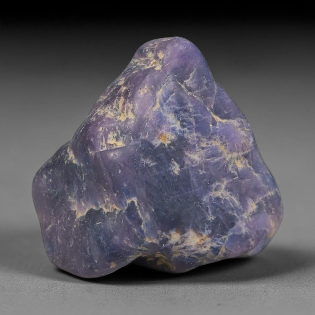 33ct Natural Unheated Sri Lankan Purplish Blue Sapphire Rough, 96YQ: This natural corundum rough is an unheated purplish blue sapphire sourced from Sri Lankan alluvial gem deposits, featuring an irregular natural native form with residual pale yellow-brown mineral matr