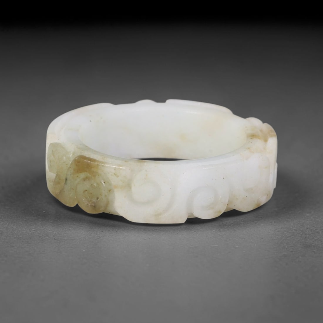 Natural Burmese Type A Jadeite Jade Carving Band Ring Size US 8.5, 18TB: Carved from untreated natural Burmese Type A jadeite jade, this carved stone band holds a soft polished finish showcasing milky pale base hues interspersed with warm natural brown mineral patina patch