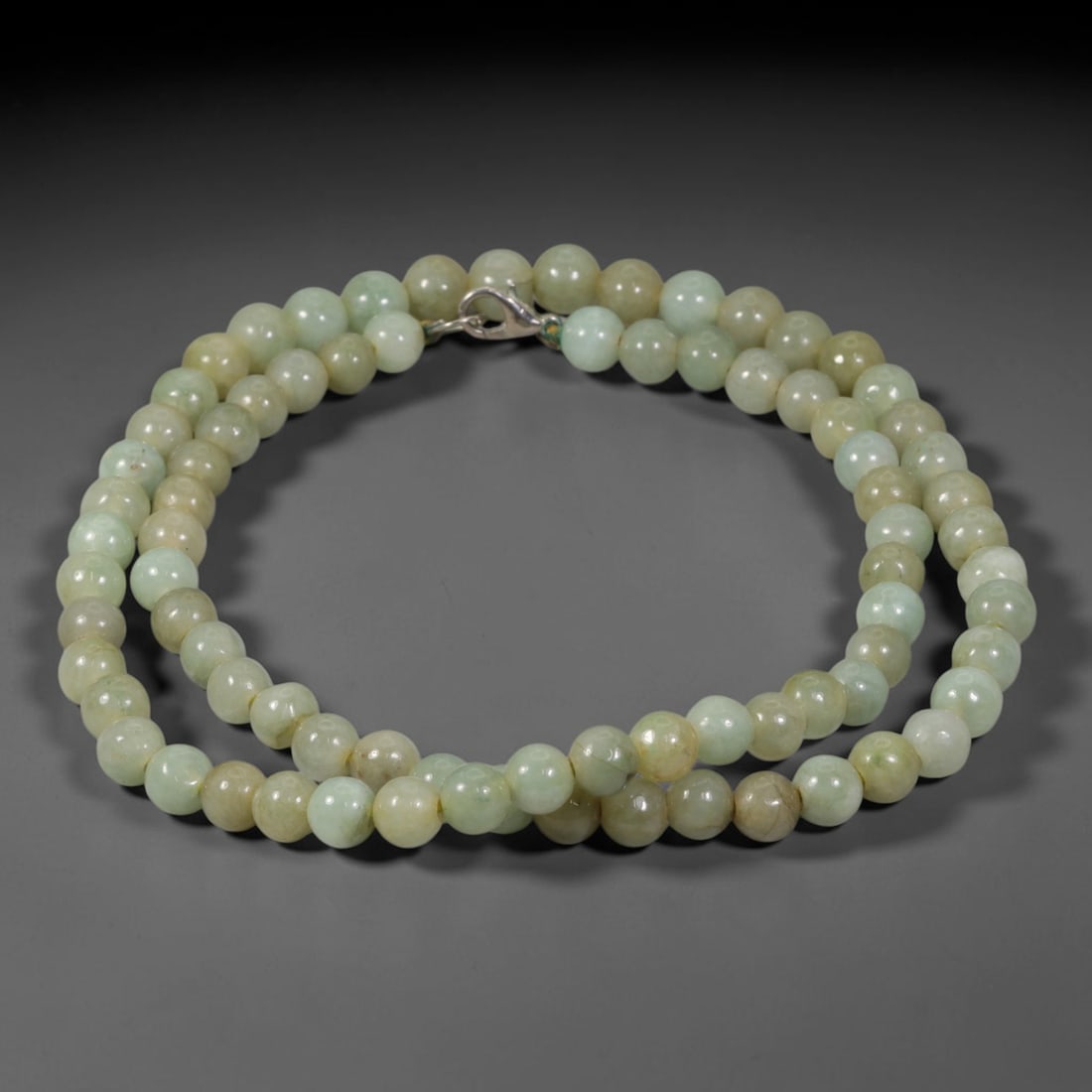 Natural Burmese Type A Pale Celadon Jadeite Jade Beaded Necklace, 1TF: Strung from untreated natural Burmese Type A jadeite jade spherical beads measuring 7.68mm in diameter, this full strand features a smooth consistent polish showcasing soft pale celadon stone tones mi