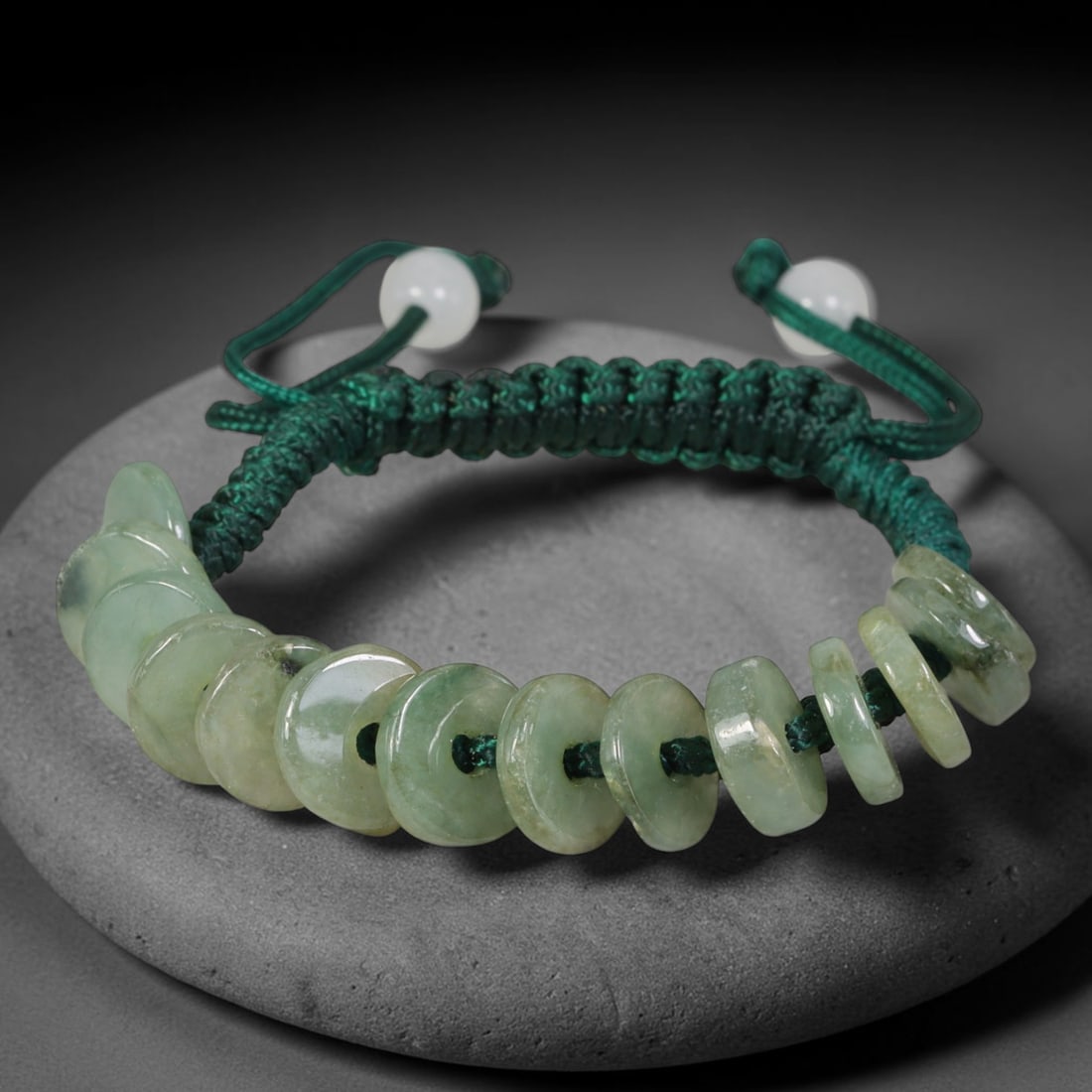 Natural Burmese Type A Pale Green Donut Jadeite Jade Adjustable Braided Bracelet, 58TA: Handcrafted from untreated natural Burmese Type A translucent pale green jadeite, this braided cord bracelet features graduated flat circular donut beads with each disc measuring 10.32 mm in thickness