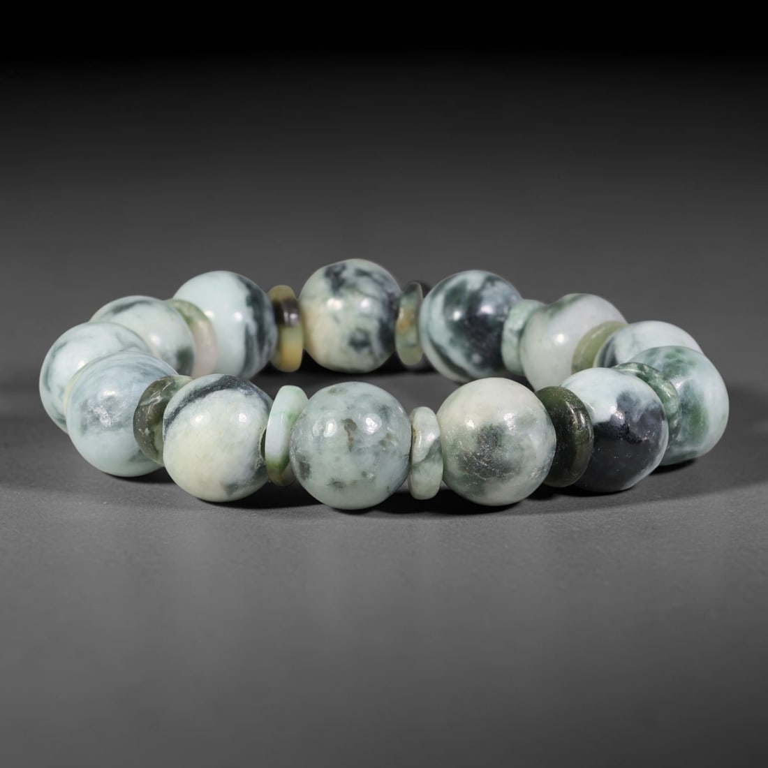 Natural Burmese Type A Dark Swirl Mottled Jadeite Jade Bead Bracelet, 6TP: Strung from natural Type A Burmese jadeite, this substantial spherical bead bracelet features a pale milky base layered with dramatic deep forest green and near-black swirling cloud mottling, accented