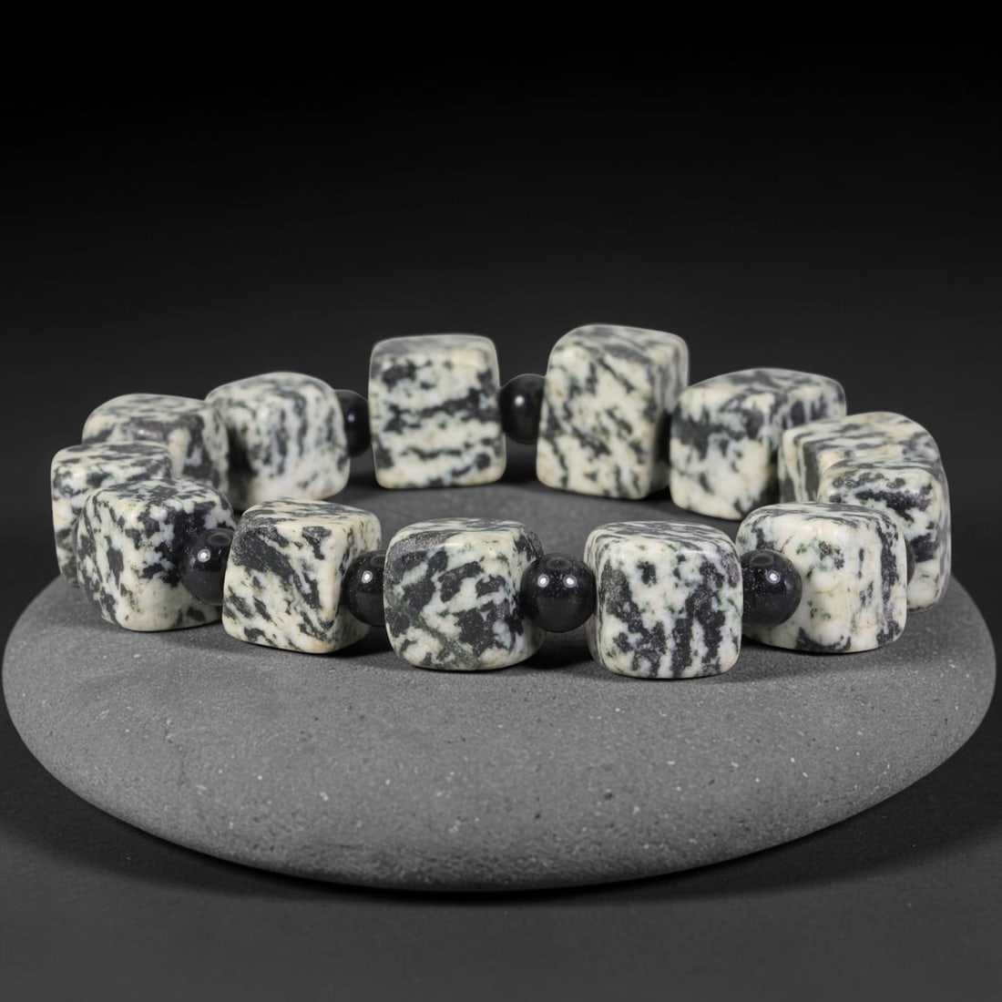 Natural Black White Zebra Jasper Cube Beaded Bracelet with Black Onyx Spacers, 49TP: Polished elastic strand bracelet hand-strung with natural zebra jasper cube beads marked by striking irregular black-and-white mottled patterns, separated by smooth glossy black onyx spacer beads. Eac