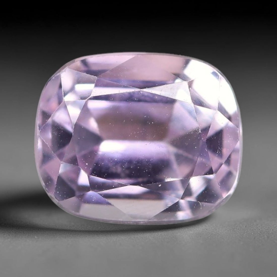 3.19ct Natural Pale Pink Lavender Kunzite Cushion Cut Loose Gemstone, 66TH: This faceted specimen is natural kunzite, fashioned in a cushion cut. The stone features a translucent pale pink lavender hue, with fine microscopic particulate inclusions dispersed throughout the cry