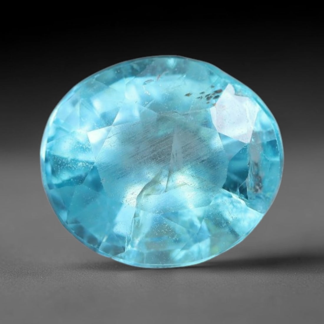 1.14 Carats Natural Bright Cyan Blue Apatite Oval Faceted Loose Gemstone, 10WW: This apatite is sourced from natural mineral deposits and processed with precise faceting and uniform high-gloss polishing by professional lapidary craftsmanship. Natural fibrous textures and tiny sca