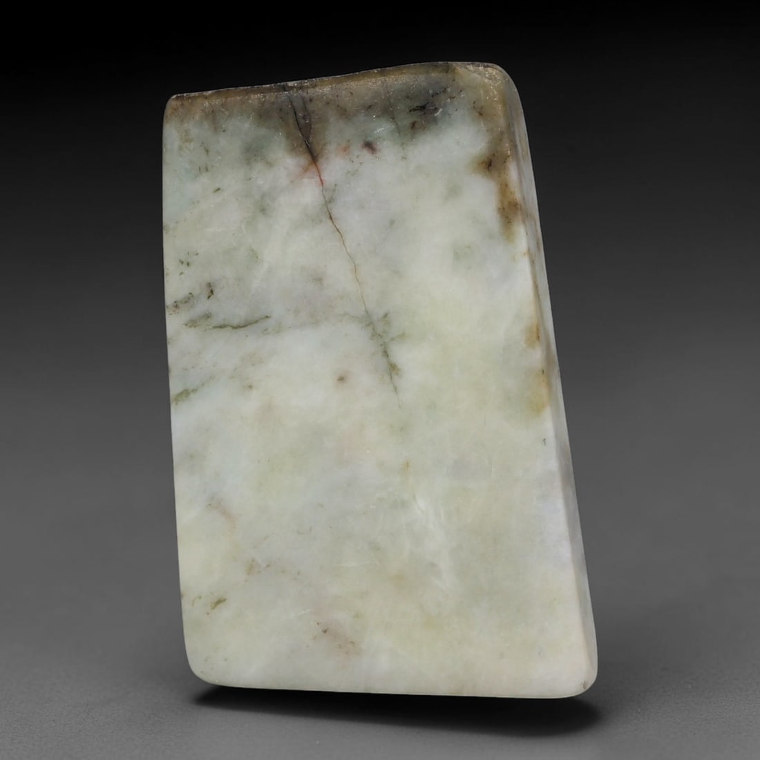 250ct Natural Type A Burmese Jadeite Jade Sliced Rough, 38YR: This specimen is a sliced rough block of natural Type A Burmese jadeite jade. The interior displays natural colour zoning with visible mineral veining and crystalline patterns typical of unprocessed j