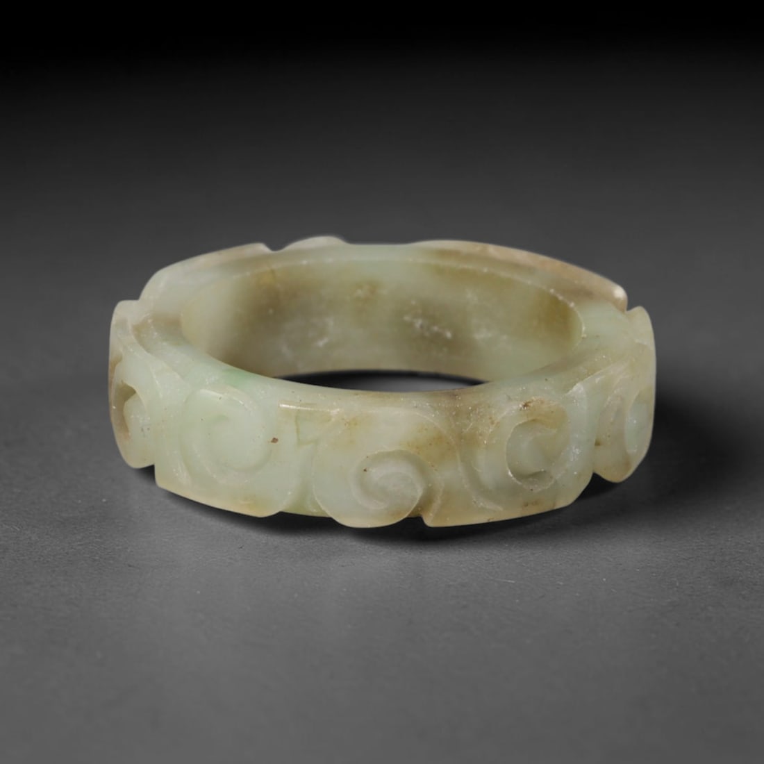 Natural Burmese Type A Jadeite Jade Carving Band Ring Size US 9, 16TB: Carved from untreated natural Burmese Type A jadeite jade, this carved stone band holds a soft polished finish showcasing milky pale base hues interspersed with warm natural brown mineral patina patch
