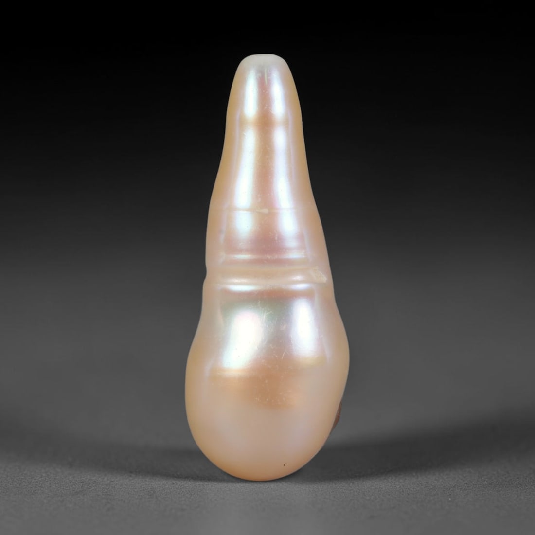 Natural Freshwater Baroque Pearl - Cream Peach Tapered Elongated Form, 61WE: This natural freshwater baroque pearl features a distinctive tapered elongated organic silhouette wrapped in smooth, lustrous iridescent nacre with warm cream and soft peach shifting overtones across 