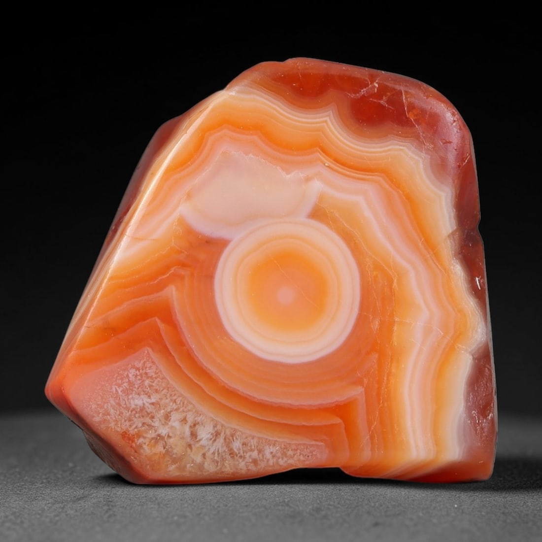97ct Natural Brazilian Carnelian Banded Agate Sliced Rough Slab, 88YK: This polished slice specimen is natural carnelian banded agate sourced from Brazilian deposits, featuring concentric layered banding of rich orange, peach, and deep crimson-red chalcedony. One flat fa