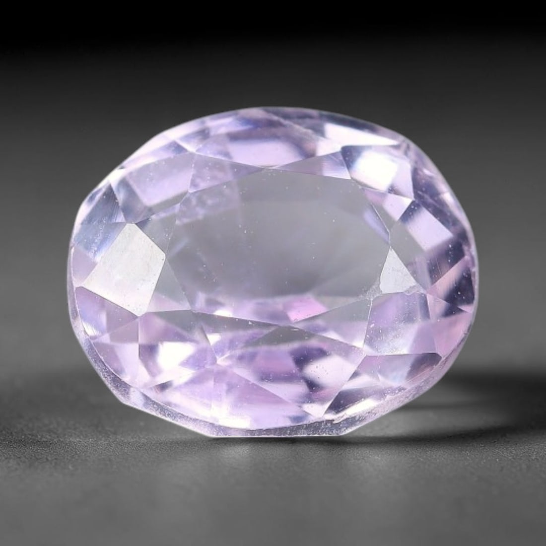 3.19ct Natural Pale Lavender Kunzite Oval Cut Loose Gemstone, 63TH: This faceted specimen is natural kunzite, fashioned in an oval brilliant cut. The stone presents a translucent pale lavender hue, with fine microscopic inclusions scattered throughout the crystal matr