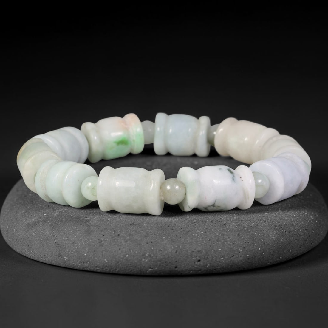 Natural Burmese Type A Carved Waisted Barrel Jadeite Jade Bead Bracelet, 14TP: Strung from natural Type A Burmese jadeite, this bracelet features carved waisted barrel beads in milky white base with soft scattered green flecks and faint greyish mineral mottling. Each sculpted ba