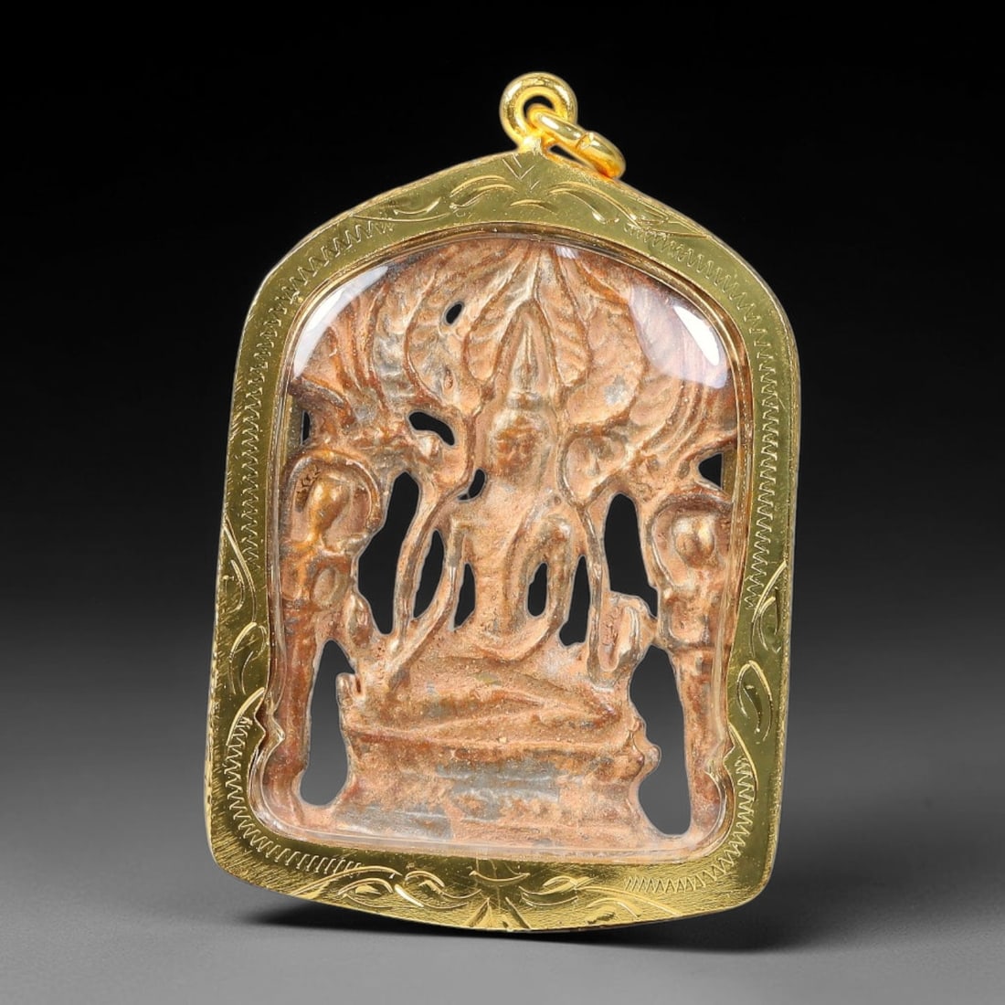 Thai Clay Buddha Amulet - Gold Cased Votive Pendant, 4YY: Hand-molded clay devotional piece featuring openwork seated Buddha relief beneath stylized bodhi leaf motifs, flanked by attendant carved figures following traditional Thai votive craft styles. The te