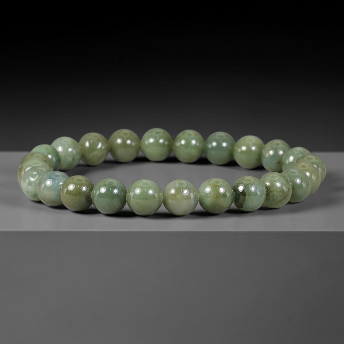 Natural Burmese Type A Muted Sage Green Jadeite Jade Bead Bracelet, 30TP: Strung from natural Type A Burmese jadeite, this spherical bead bracelet carries a calm muted sage green tone with subtle natural mineral veining and gentle tonal shifts across each bead. Every bead i