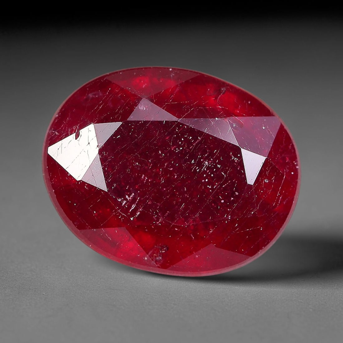 2.63 Carats Natural Madagascar Ruby Oval Faceted Loose Gemstone, 42TM: This sizable natural Madagascar ruby is cut into an oval brilliant faceted form, showcasing rich saturated crimson red hue characteristic of Malagasy corundum. Extensive natural internal silk veining,