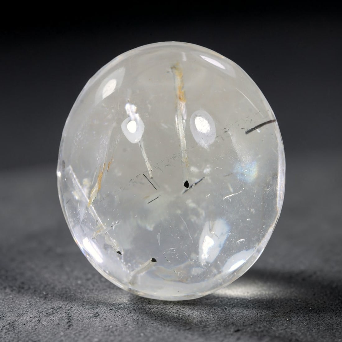 50.21ct Natural Brazilian Black Rutile Quartz Cabochon Loose Gemstone, 20YX: This polished cabochon of natural rutile quartz features countless distinct slender black rutile needle inclusions suspended within the clear quartz host crystal. The smooth domed surface enables full