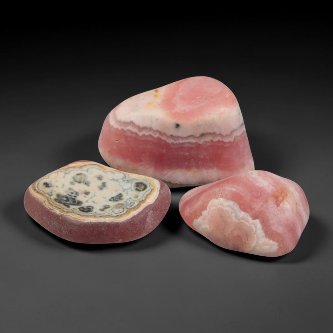 80ct 3pcs Natural Argentine Rhodochrosite Banded Tumbled Rough Set, 12YR: This listing features three individual tumbled rhodochrosite rough pieces sourced from Argentina Capillitas deposits, each showcasing distinct layered banding of soft rose pink, cream white and pale t