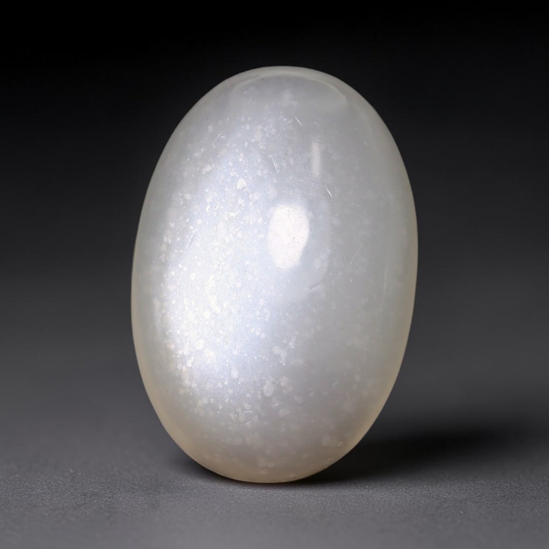 30.14 Carats Natural Ceylon Soft Milky White Moonstone Oval Cabochon Loose Gemstone, 64TM: This soft milky white Ceylon moonstone oval cabochon displays a uniform translucent pale cream feldspar base with faint diffused adularescent glow across its smoothly domed polished surface. A single 