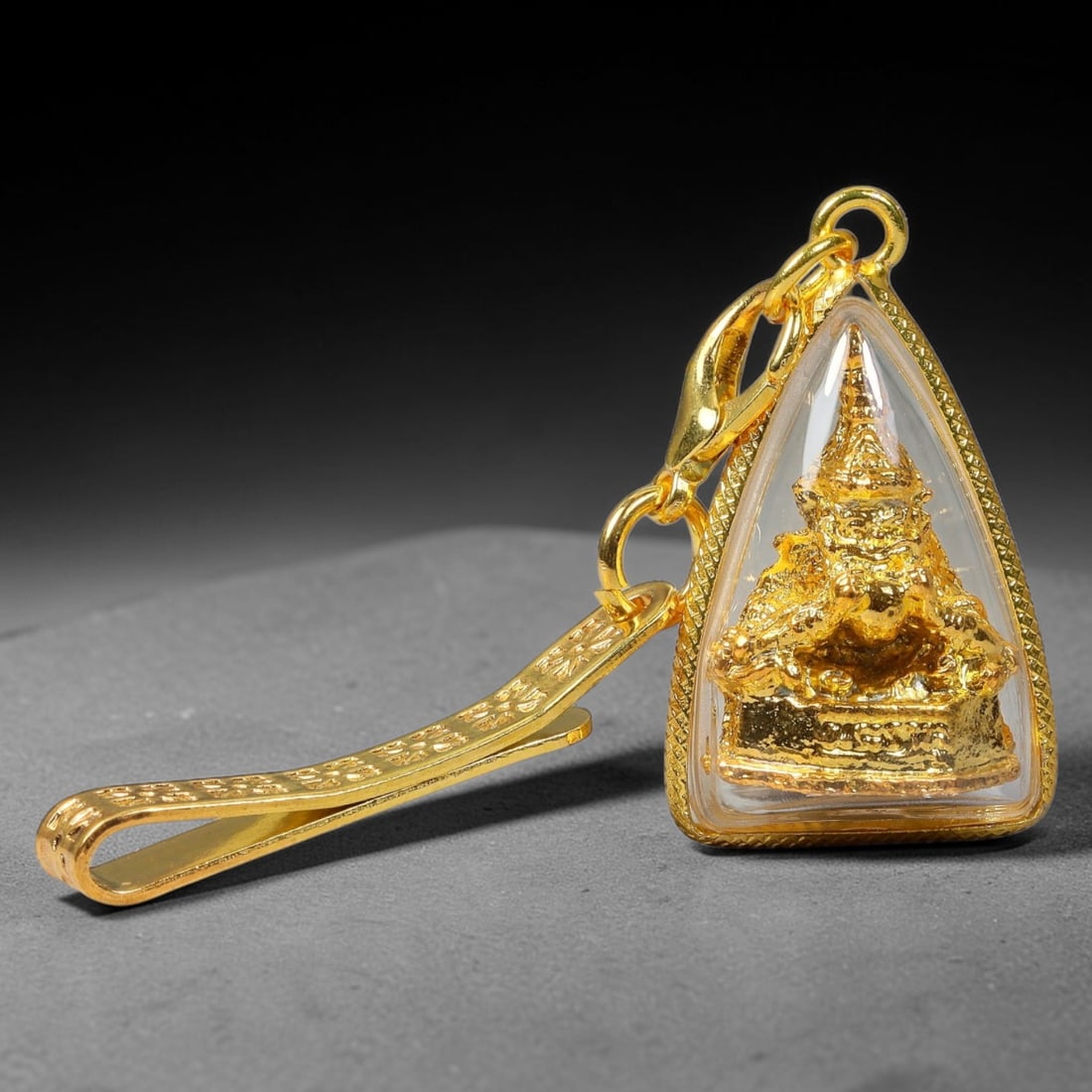 Thai Golden Phra Rahu Triangle Amulet Pendant with Engraved Gold Clip, 21YY: Triangular Thai spiritual talisman sealed inside polished textured gold casing with clear transparent dome cover, showcasing a detailed embossed golden Phra Rahu deity figurine visible on both sides. 