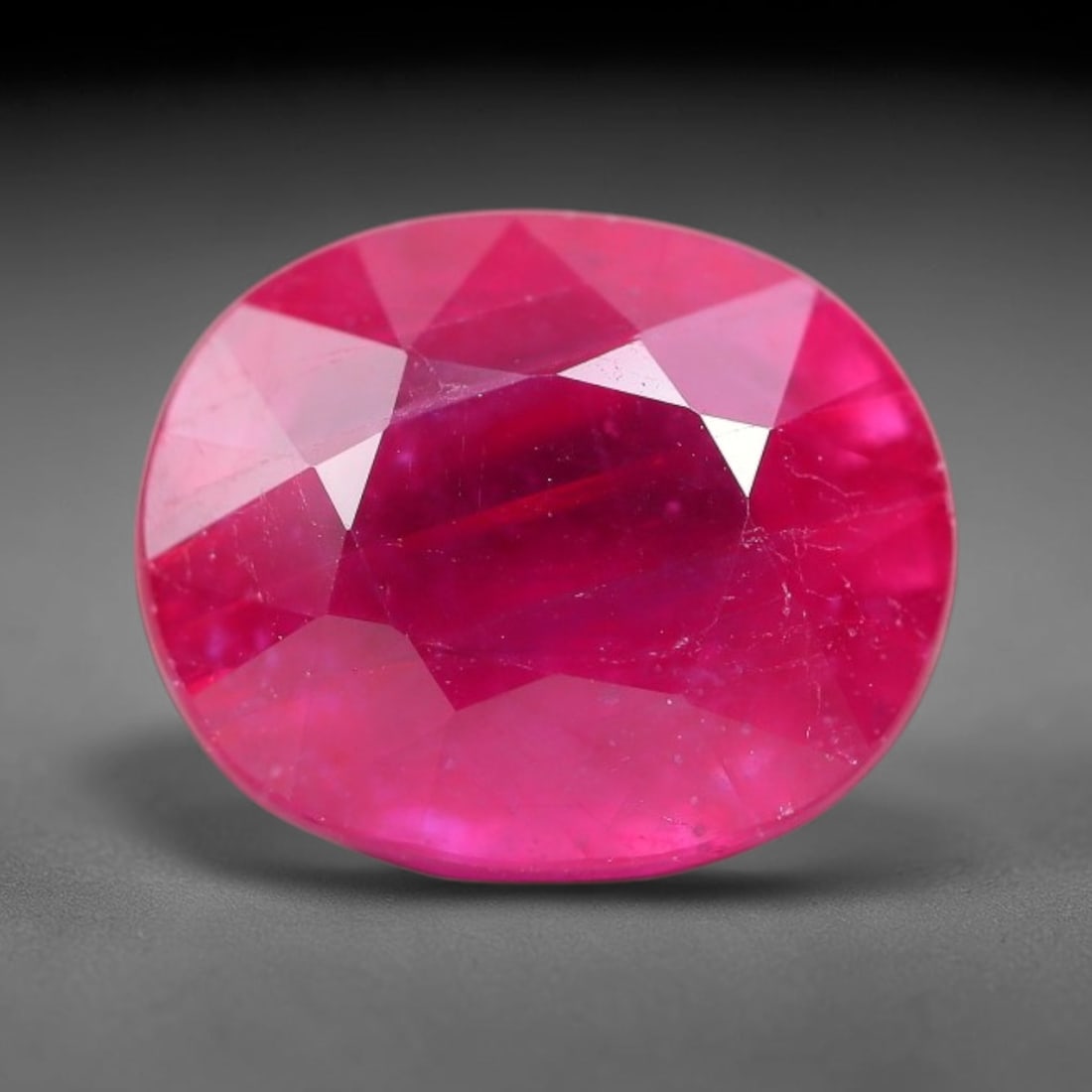 7.84 Carats Natural Mozambique Ruby Oval Faceted Loose Gemstone, 79TM: This natural Mozambique ruby is fashioned with standard oval brilliant faceting, displaying vivid saturated crimson-red hue accompanied by native fine mineral inclusions and subtle trace marks inheren