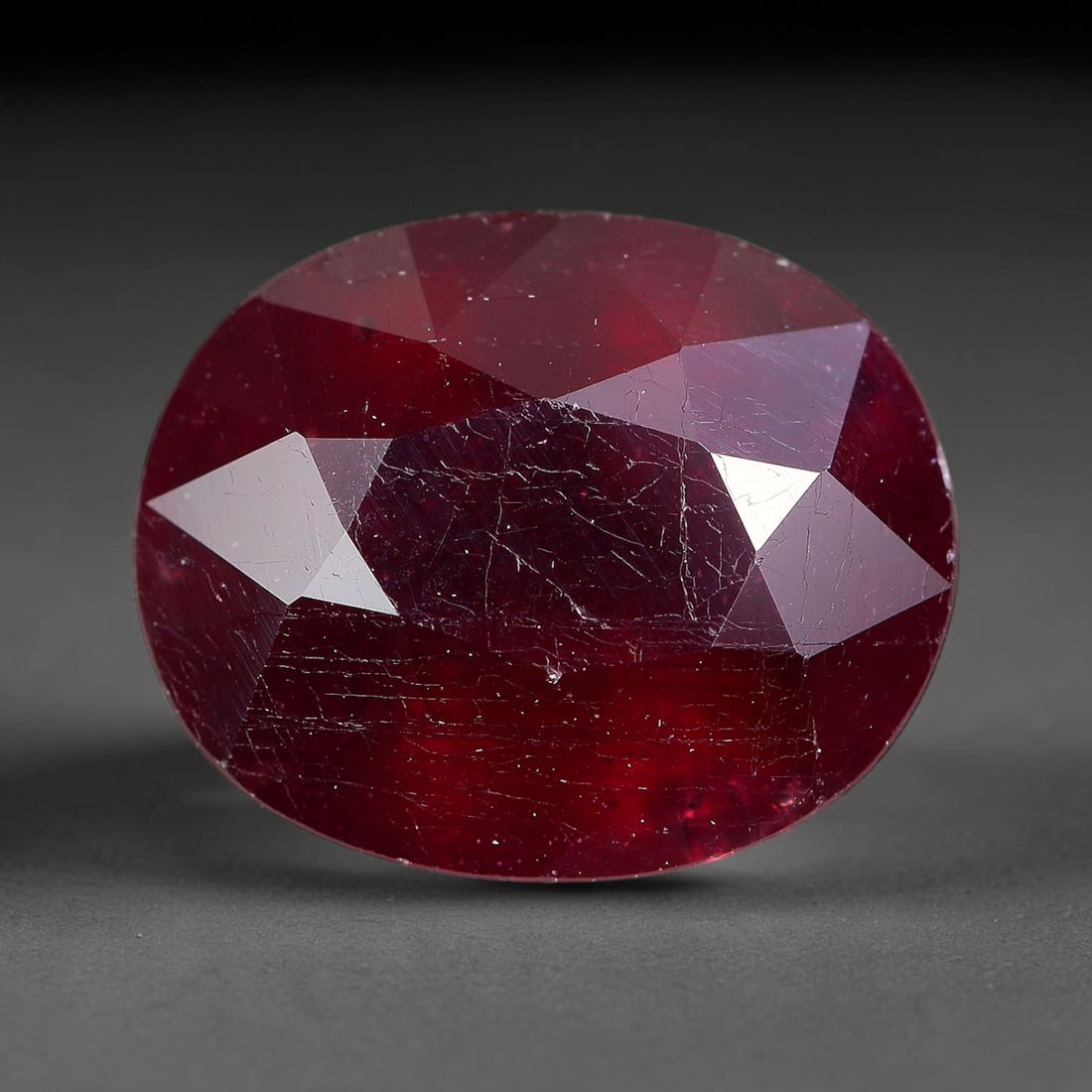 5.50 Carats Natural Madagascar Ruby Oval Faceted Loose Gemstone, 28TM: This sizable natural Madagascar ruby is cut into an oval brilliant faceted form, showcasing rich saturated crimson red hue characteristic of Malagasy corundum. Extensive natural internal silk veining,