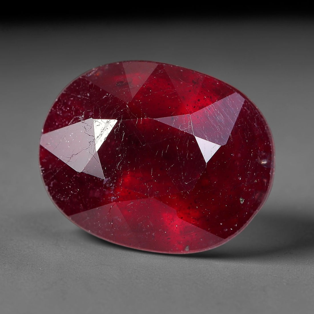 3.69 Carats Natural Madagascar Ruby Oval Faceted Loose Gemstone, 32TM: This sizable natural Madagascar ruby is cut into an oval brilliant faceted form, showcasing rich saturated crimson red hue characteristic of Malagasy corundum. Extensive natural internal silk veining,