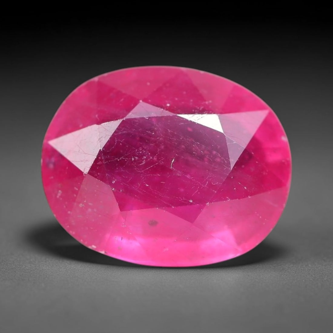 6.47 Carats Natural Mozambique Ruby Oval Faceted Loose Gemstone, 85TM: This natural Mozambique ruby is fashioned with standard oval brilliant faceting, displaying vivid saturated crimson-red hue accompanied by native fine mineral inclusions and subtle trace marks inheren