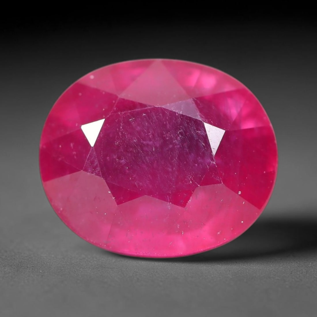 14.17 Carats Natural Mozambique Ruby Oval Faceted Loose Gemstone, 68TM: This natural Mozambique ruby is fashioned with standard oval brilliant faceting, displaying vivid saturated crimson-red hue accompanied by native fine mineral inclusions and subtle trace marks inheren