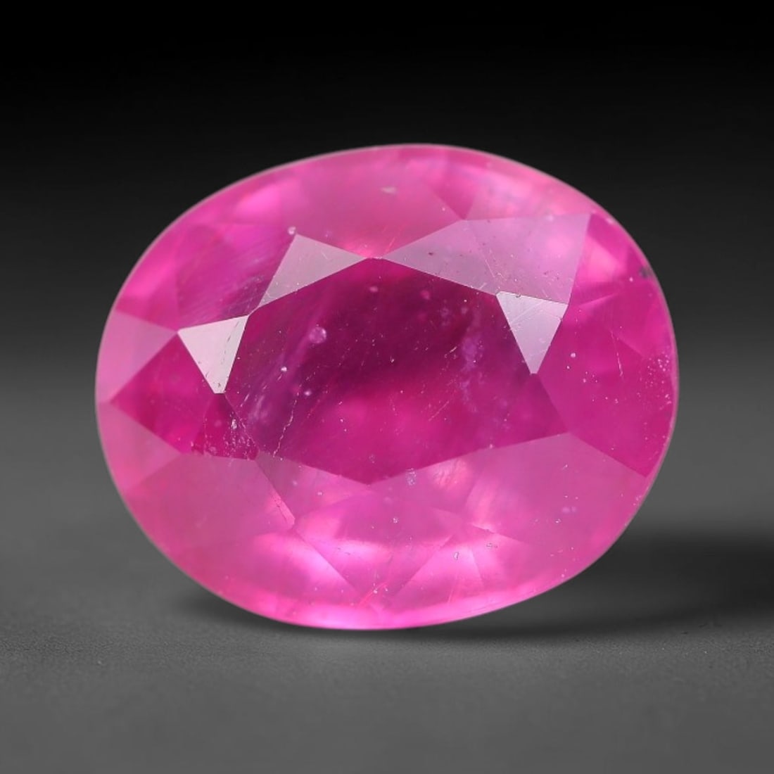 8.53 Carats Natural Mozambique Ruby Oval Faceted Loose Gemstone, 70TM: This natural Mozambique ruby is fashioned with standard oval brilliant faceting, displaying vivid saturated crimson-red hue accompanied by native fine mineral inclusions and subtle trace marks inheren