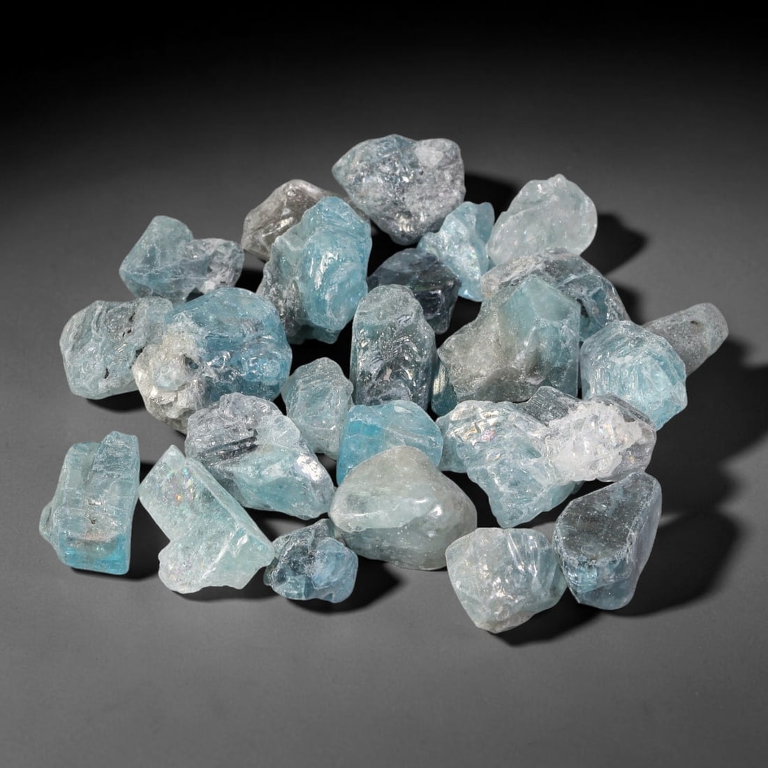 184.98ct Natural Cambodian Blue Zircon Rough Parcel Loose Gemstone, 83YT: This parcel consists of natural unpolished blue zircon rough crystals with translucent sky-blue to teal hues, featuring natural crystalline textures and facets. Minor matrix and inclusions are visible