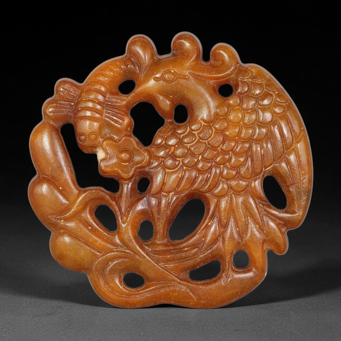 A Chinese Open-Work Carved Brown Jade Stone Pendant, 72WT: Well-crafted pierced open-work Jade Stone pendant in rich warm brown tone. Detailed relief carving across the front face with numerous hollow cut-out openings creating layered visual depth. Smooth pol