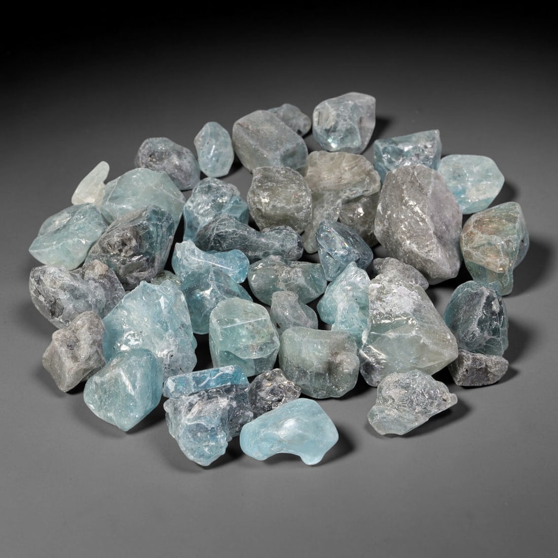 256.57ct Natural Cambodian Blue Zircon Rough Parcel Loose Gemstone, 81YT: This parcel consists of natural unpolished blue zircon rough crystals with translucent sky-blue to teal hues, featuring natural crystalline textures and facets. Minor matrix and inclusions are visible